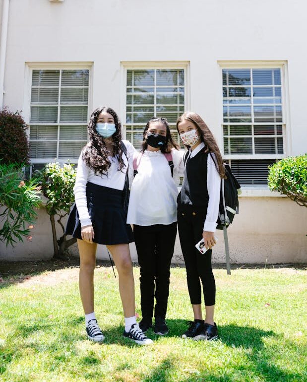 Students in mask in front of school